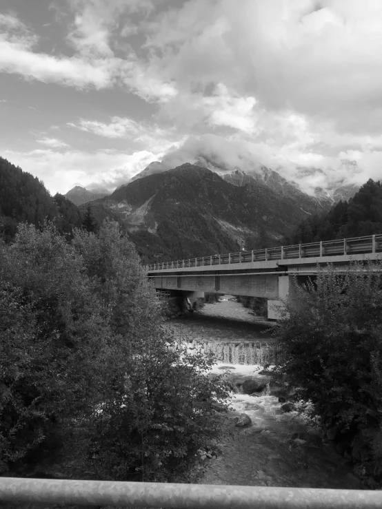 a bridge crosses over a river and a mountain