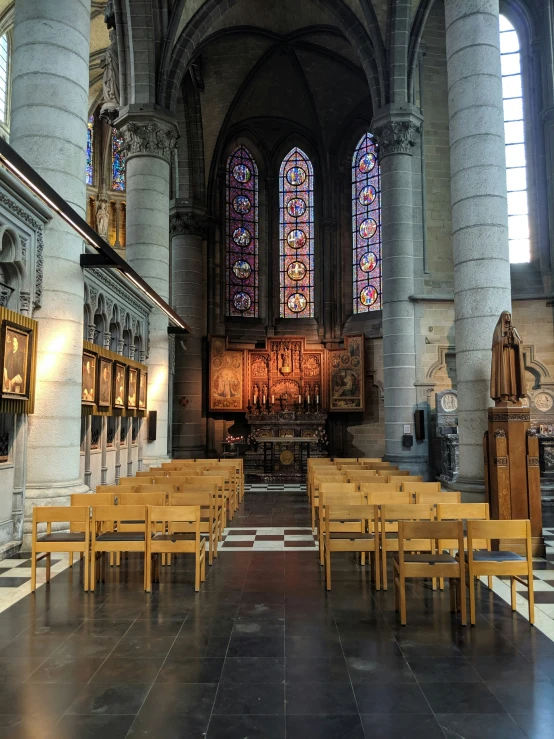 benches line the hall in an old looking cathedral