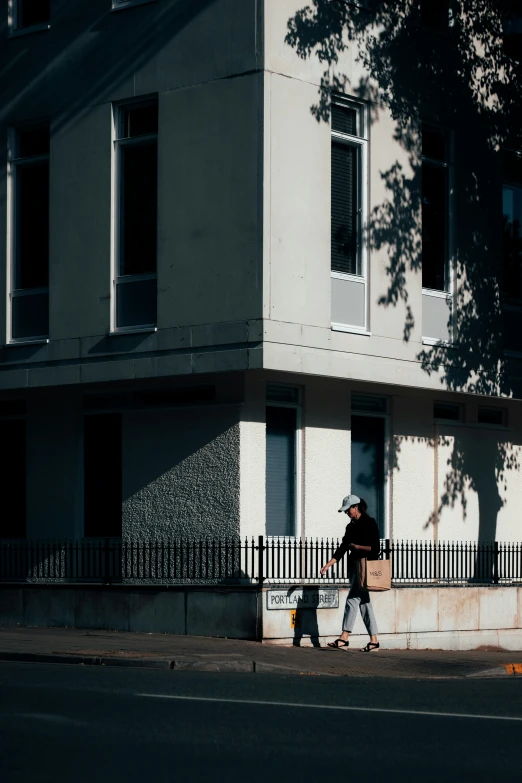 a couple of people that are walking near some buildings