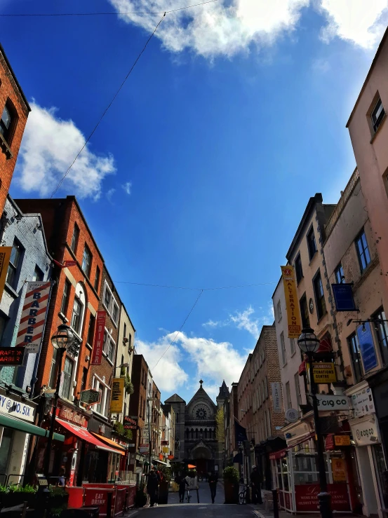 the sky is very blue over a street in town