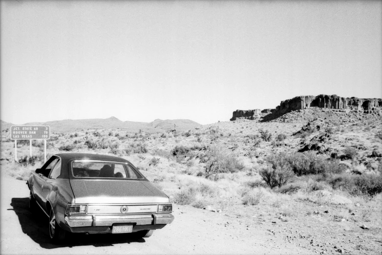 a car sitting in the middle of nowhere in the desert