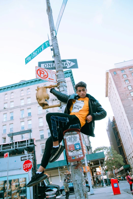 a man on a metal pole in a city