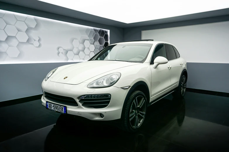 a white porsche cayen in a showroom