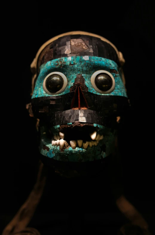a green mask with a surprised look on it