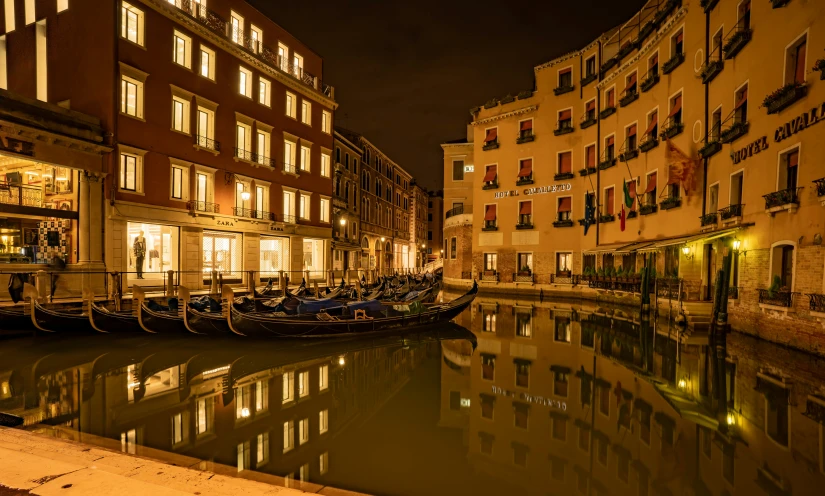 some water buildings lights and a gondola