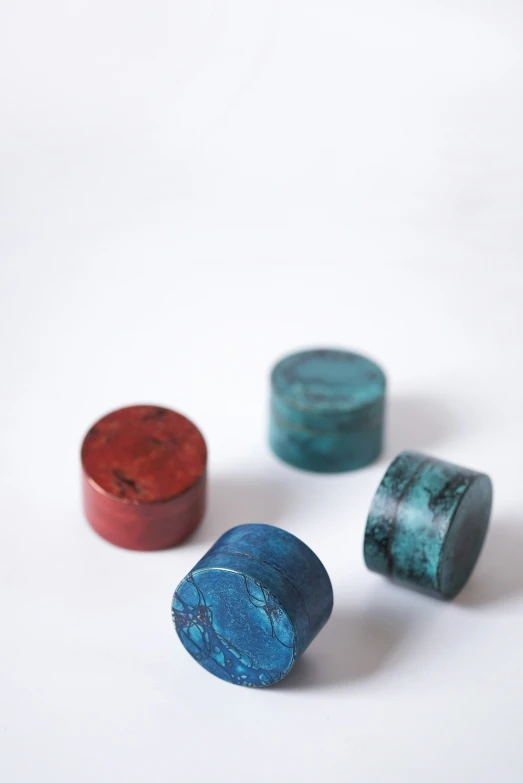 three red and one blue marbles sitting next to each other