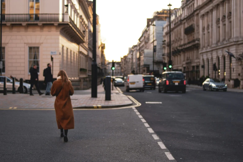 a woman in a dress walking down a street