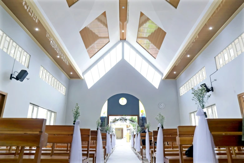 a church with white and black decor with tall windows