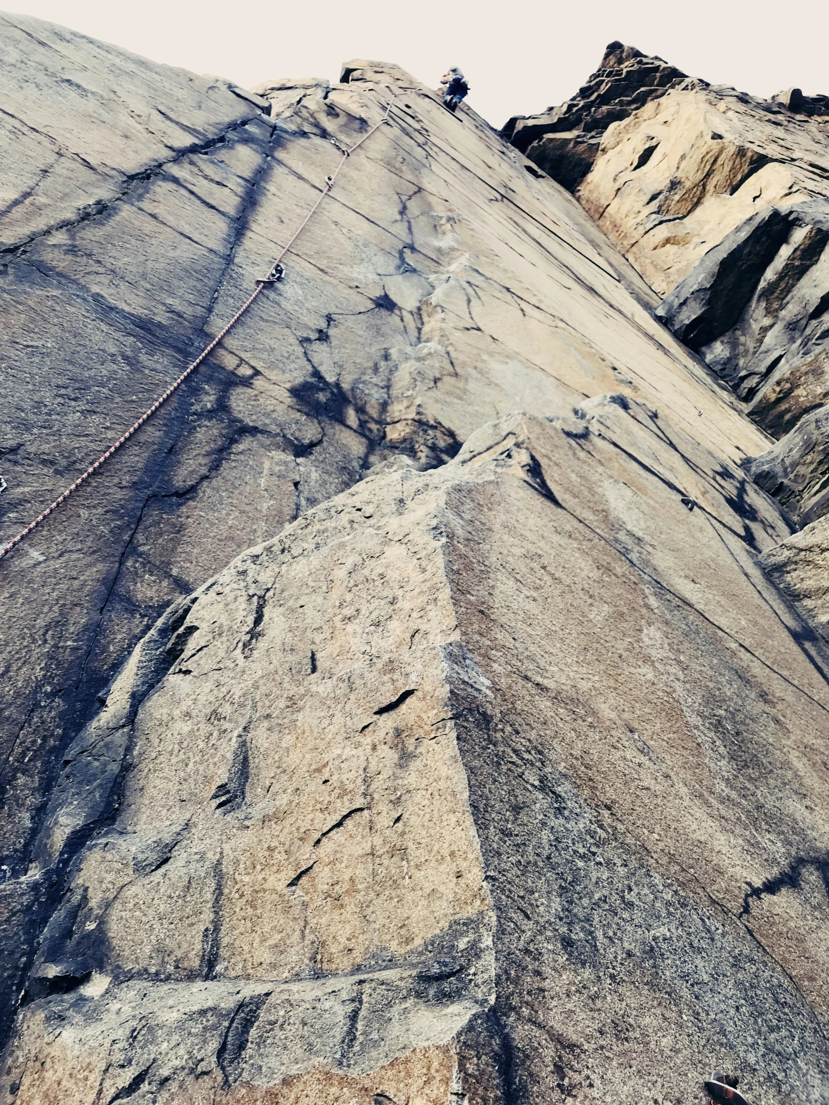 a man standing on top of a mountain cliff