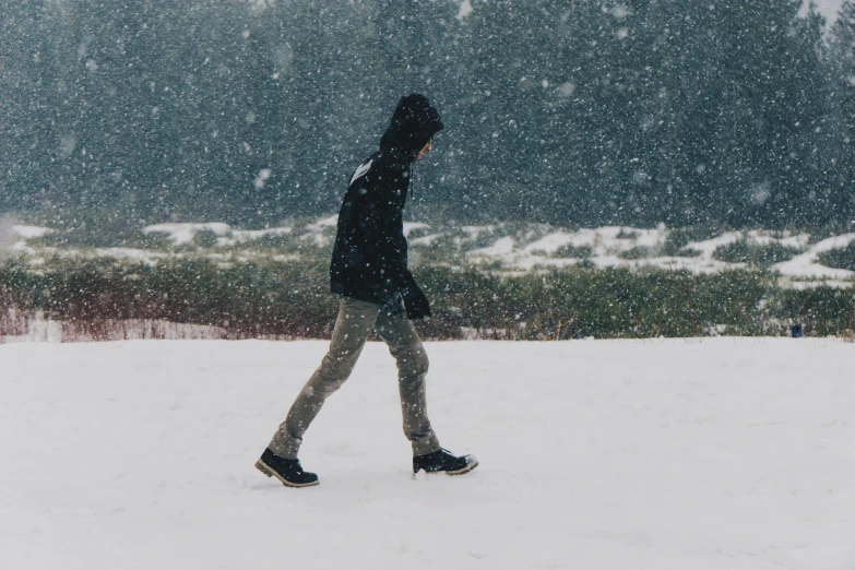 the snow is falling and there is a person on a skateboard