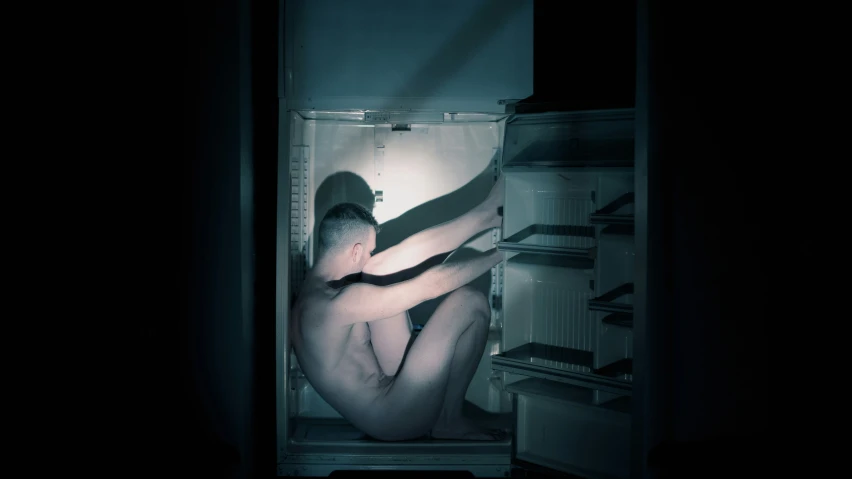 an image of someone's  torso in the fridge