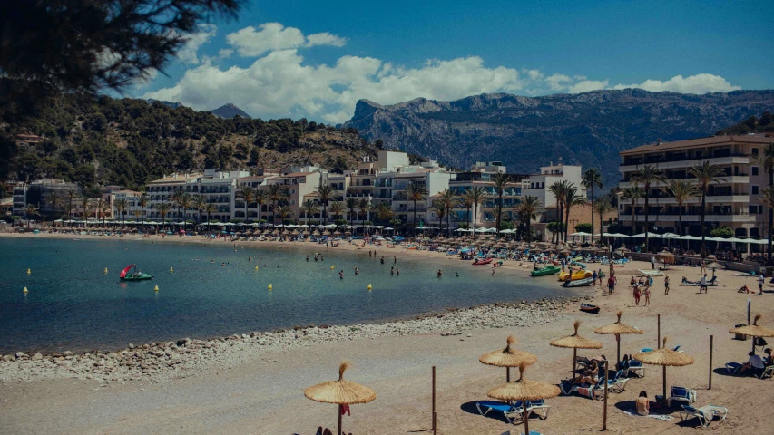 a beach with umbrellas and palm trees surrounding