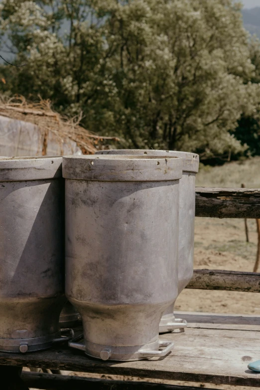 two empty barrels sitting on the ground