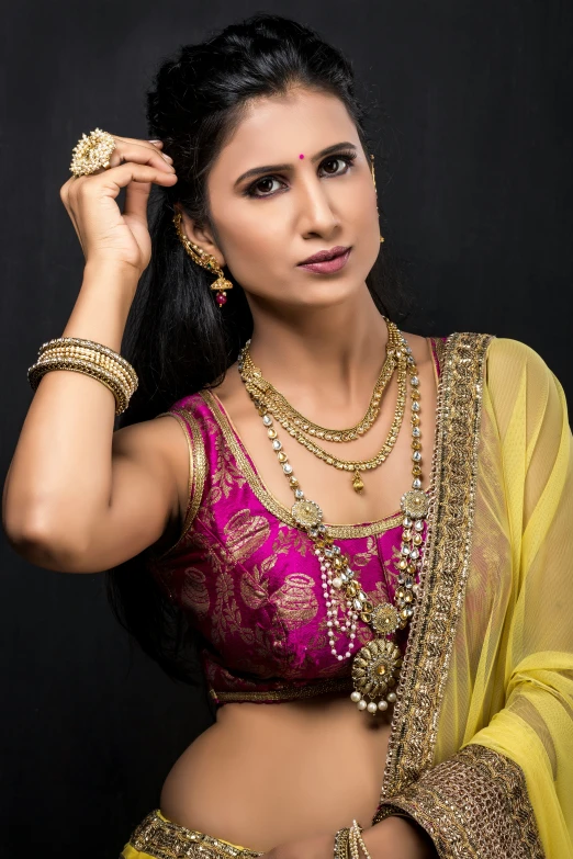 a woman wearing a saree and a necklace