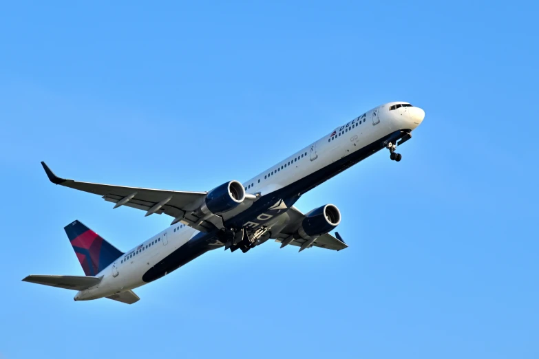 an airplane flying overhead, taking off from the airport