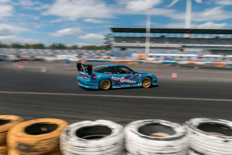 this is an image of a car racing around tires