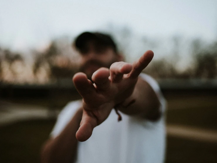 a man making the hand sign in a blurry po