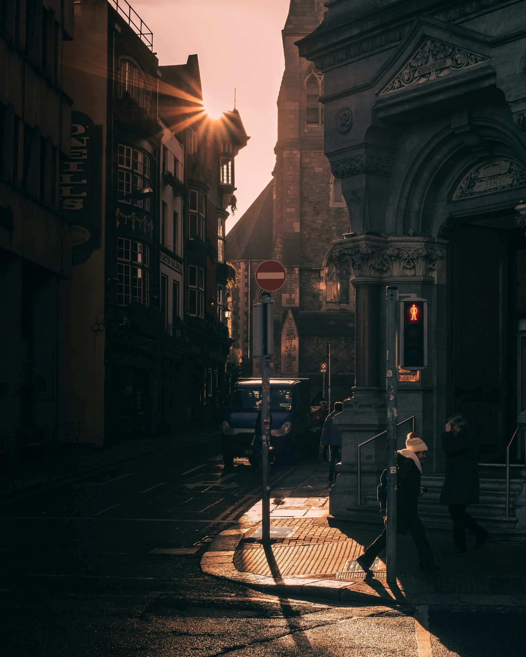 the sun is setting on a very quiet street