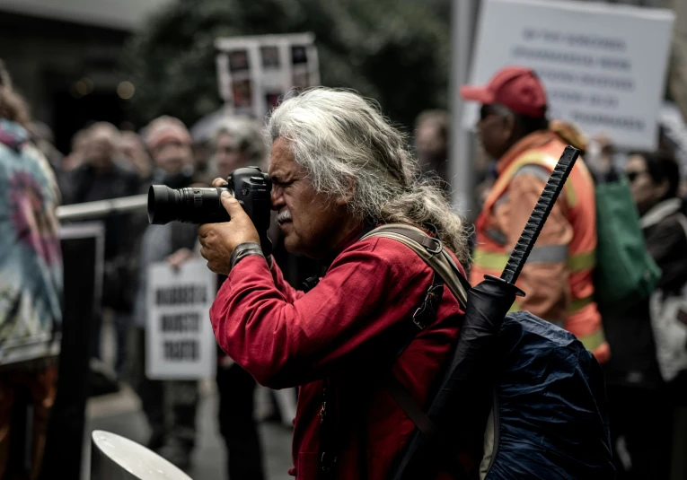 a person that is holding a camera in his hand