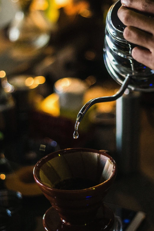 someone pouring some liquid from a jar into a glass