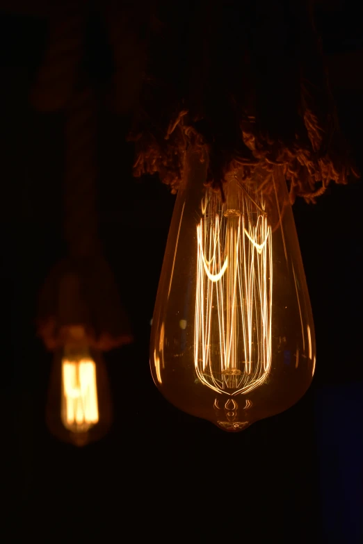 a light bulb hanging from a hook with the lights turned on