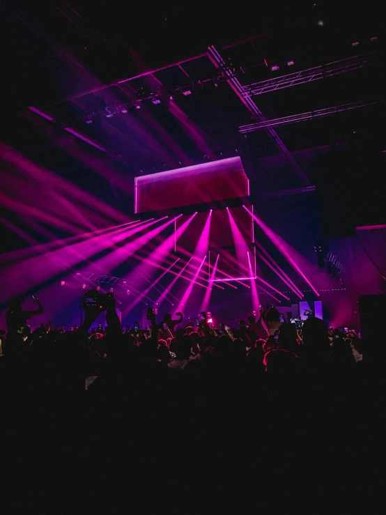 a man standing in front of a stage with bright lights