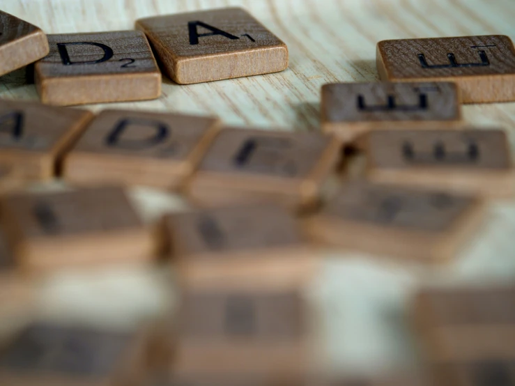 small wooden letters on top of a wood table