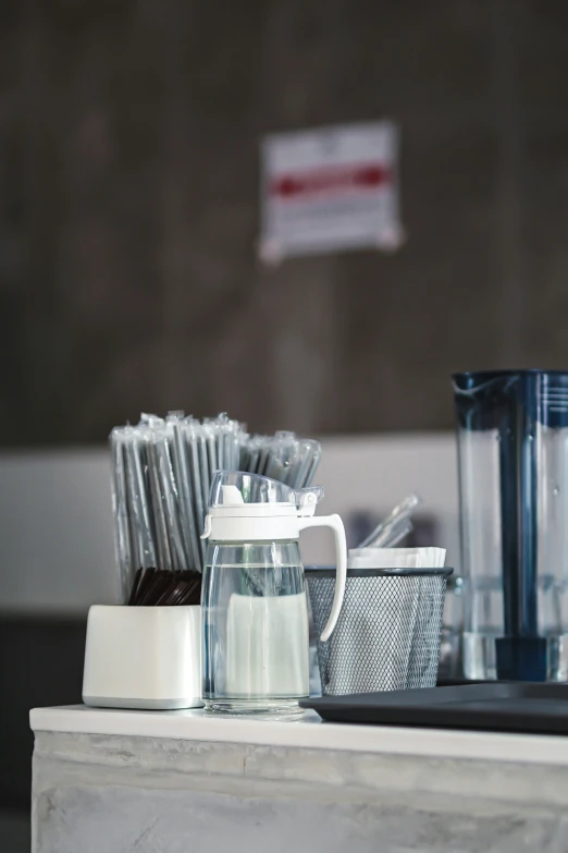 a collection of glasses, cups and other items on top of a table