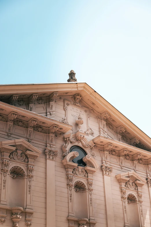 an ornate building with a clock above it's window