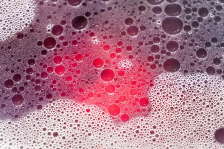 red, black and grey bubbles in water, which look like small circles