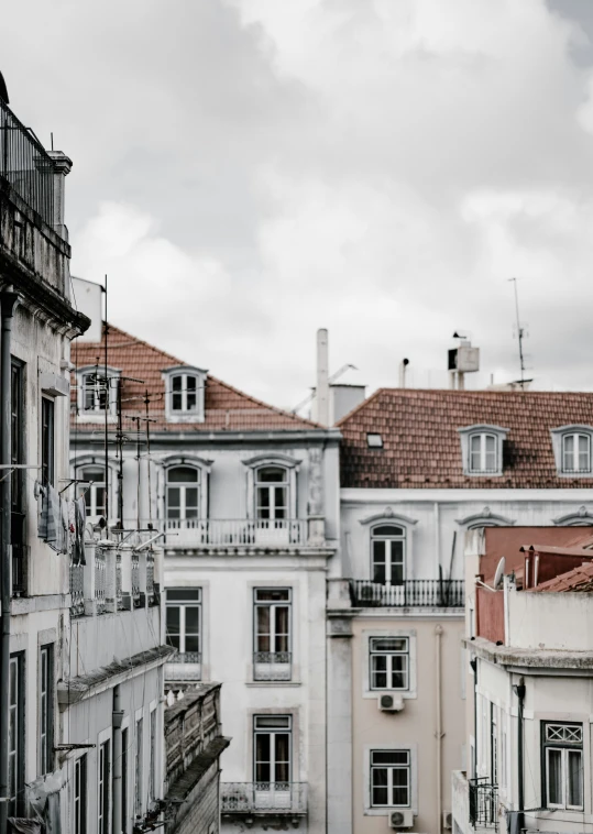 buildings with red roofs and balconyes in an urban setting