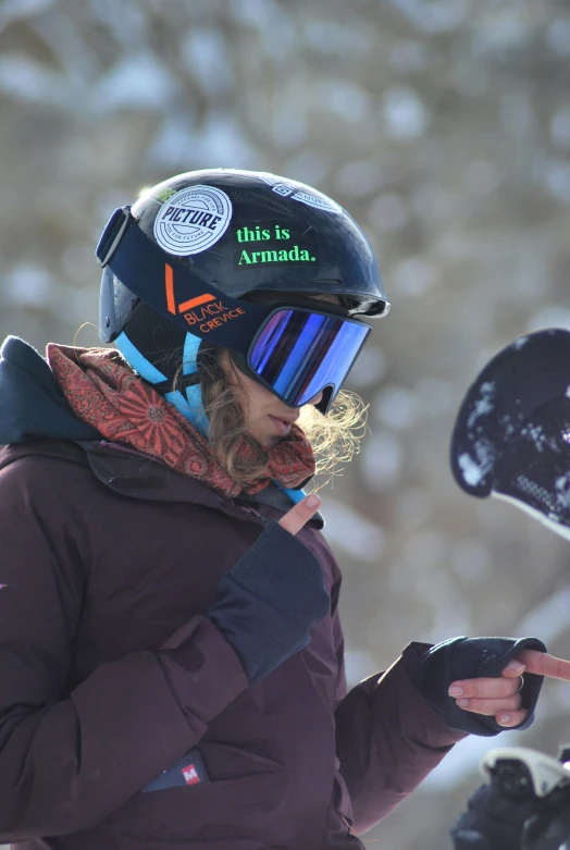 a woman wearing a helmet on a snowy day