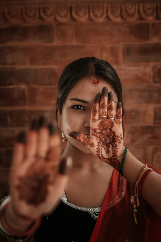 a girl showing off her henna painted on her hands