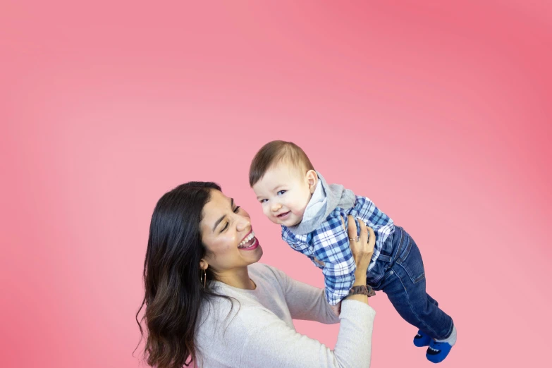 an adult holds a toddler on his chest