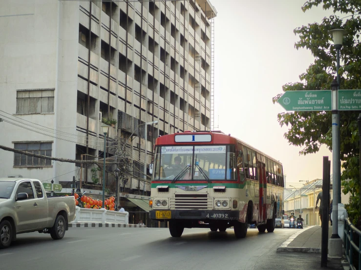 a large passenger bus driving down a busy street