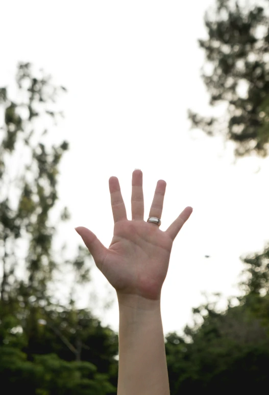 someone holding their hand up high to the sky