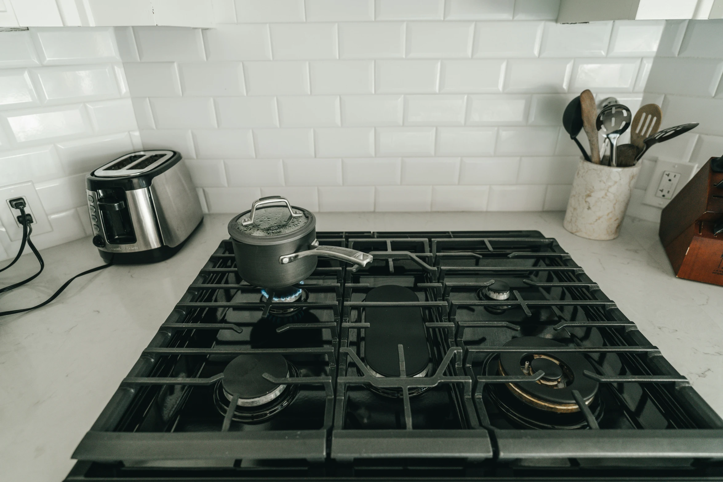 a black stove top oven with metal pots on top of it