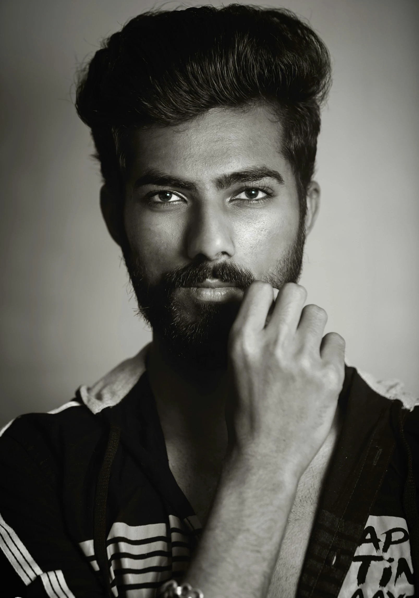 a bearded man in the pose for a black and white portrait