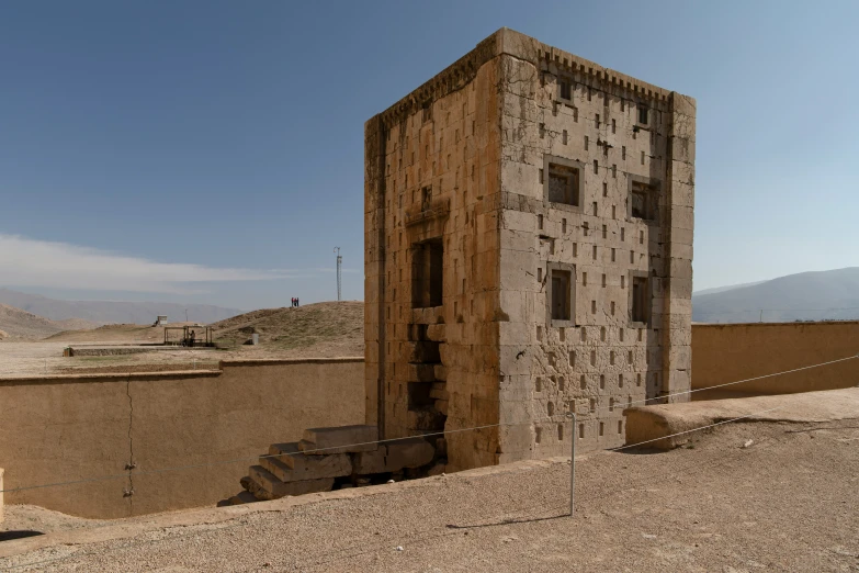 a large building with some windows in a desert