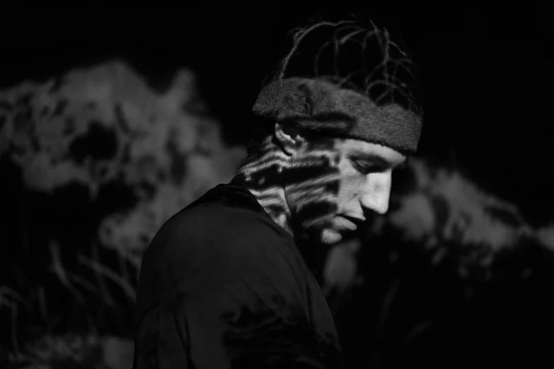 man with striped hat standing in black and white