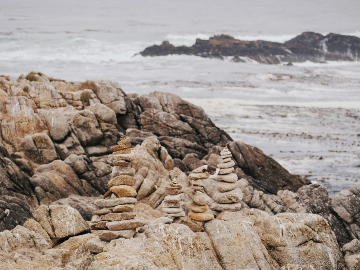 rocks by the water with a rock formation in front