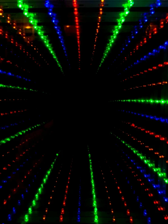 a tunnel with bright multi - colored lights in it