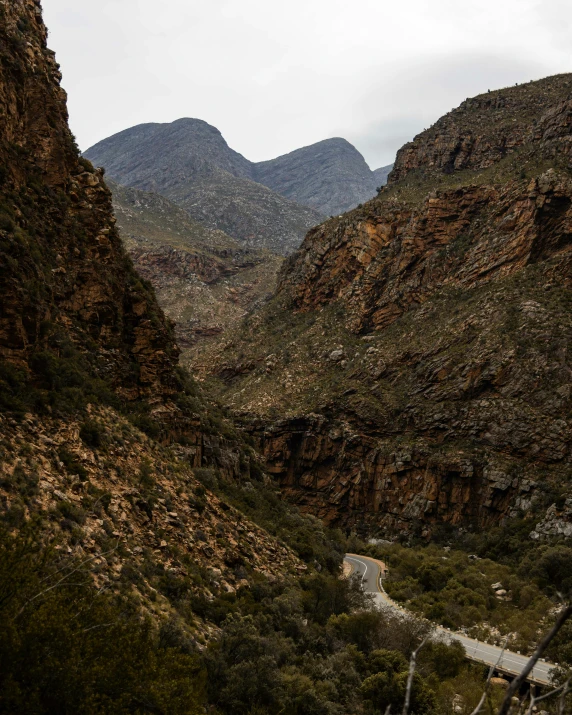 a scenic view of mountains with a road through it