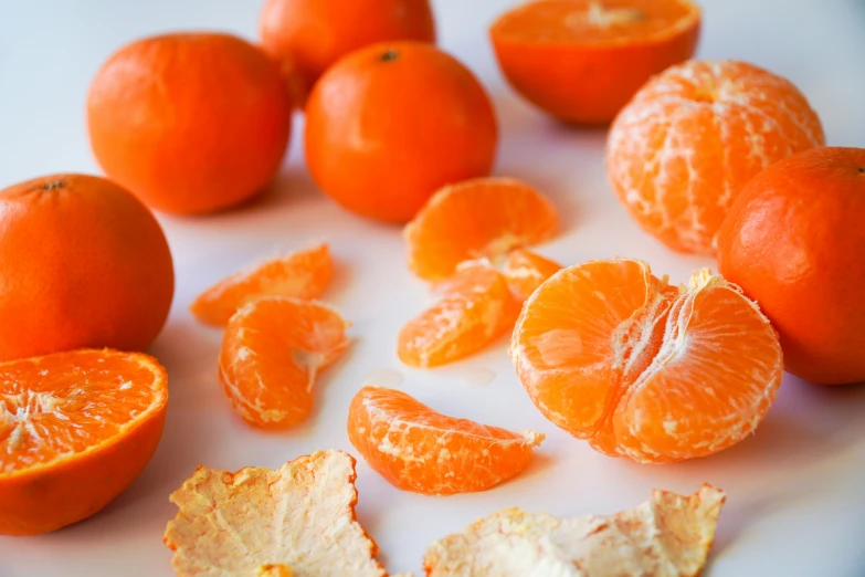 orange halves and their pulp on a white plate