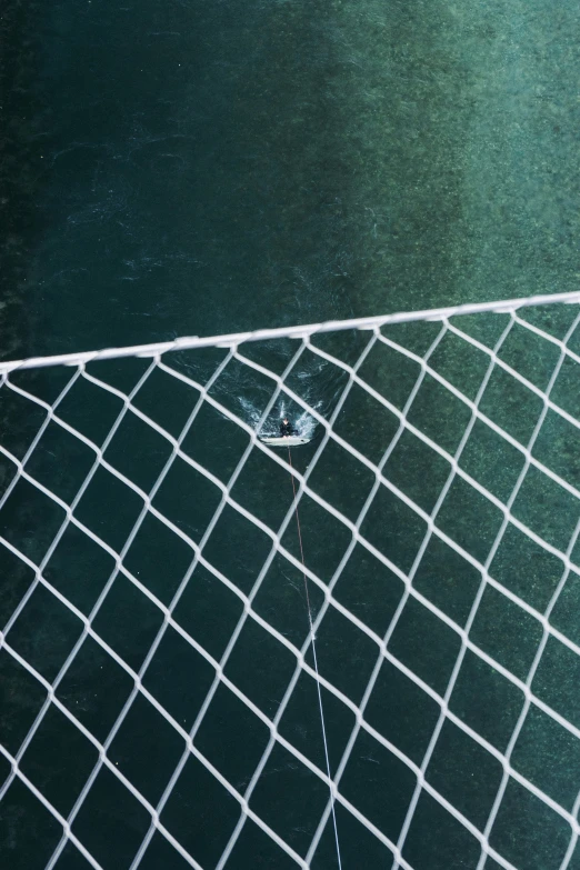 a tennis net and some tennis balls in the water