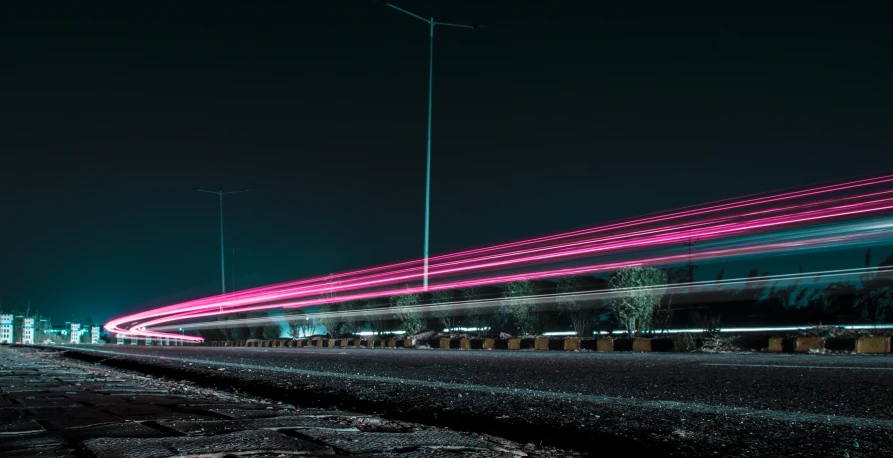 long exposure pograph of a train speeding through a city at night