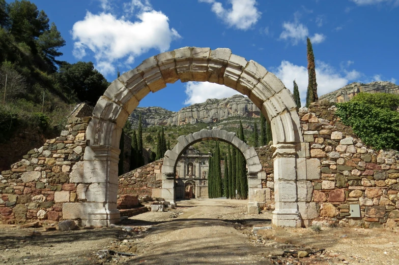 an old stone archway and some plants