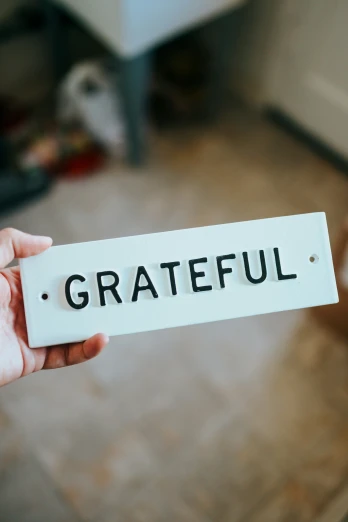 a white sign with the word grateful inside