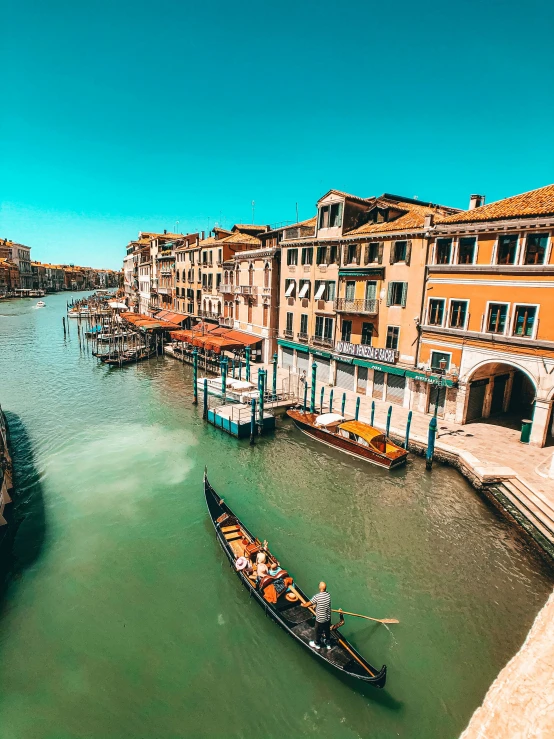 a city filled with lots of boats near buildings