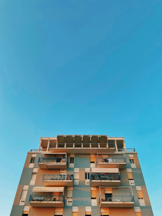 a view up at an apartment building with balcony balconies